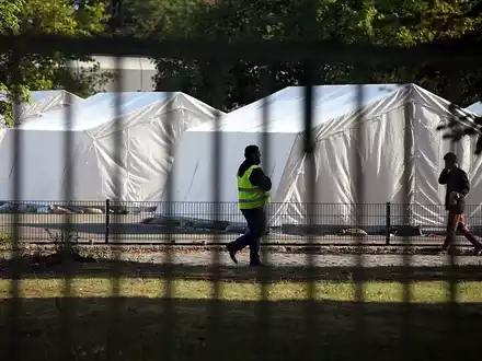 Flüchtling und Sicherheitsmann in einer Zeltstadt (Archiv) - Foto: über dts Nachrichtenagentur