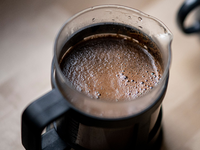 Geröstete Kaffeebohnen liegen auf einem Tisch. In der Woche vor Weihnachten senkt Aldi die Preise für Kaffee deutlich. Edeka, Rewe, Penny, Netto und Norma kündigten an, dem Beispiel zu folgen. - Foto: Fabian Sommer/dpa