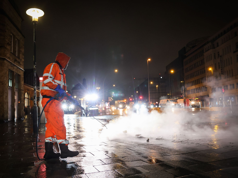 Arbeiten in der Dunkelheit: Ein Mitarbeiter der Stadtreinigung in Hamburg. - Foto: Christian Charisius/dpa