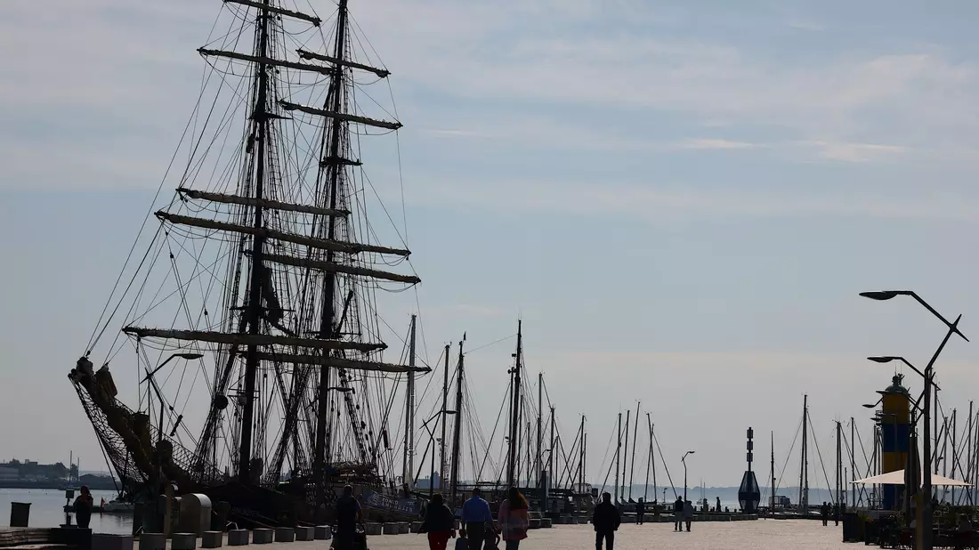 Ein Mann und eine Frau gehen an einem Deich an der Nordsee spazieren: An Niedersachsens Nordseeküste laufen die Vorbereitungen für die Saison. - Bild: Frank Molter/dpa