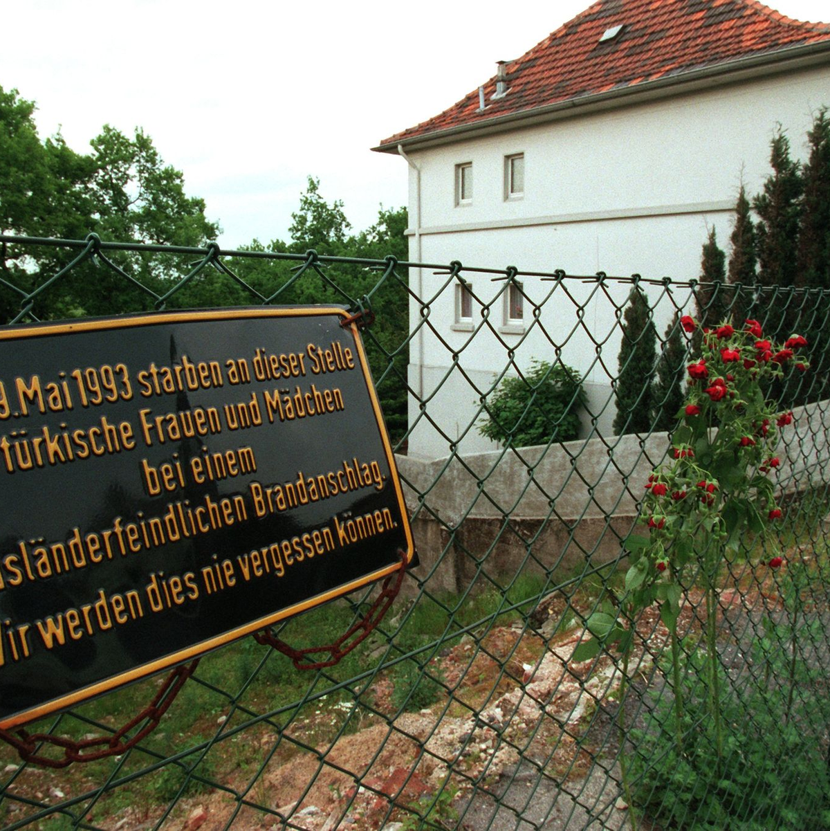 An der Stelle, wo das Haus der türkischen Familie Genc stand, erinnert heute eine Gedenktafel an die Opfer des Brandanschlags. - Foto: Martin Gerten/dpa