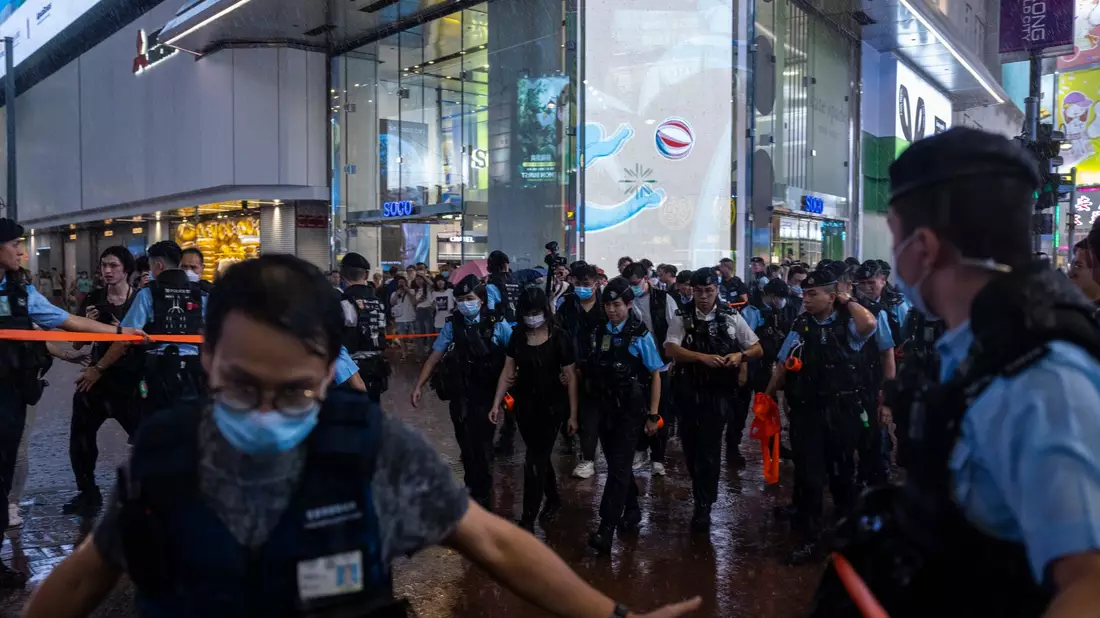 Polizeibeamte nehmen am Vorabend des 34. Jahrestages des Massakers auf dem Platz des Himmlischen Friedens eine Bürgerin mit. - Bild: Louise Delmotte/AP