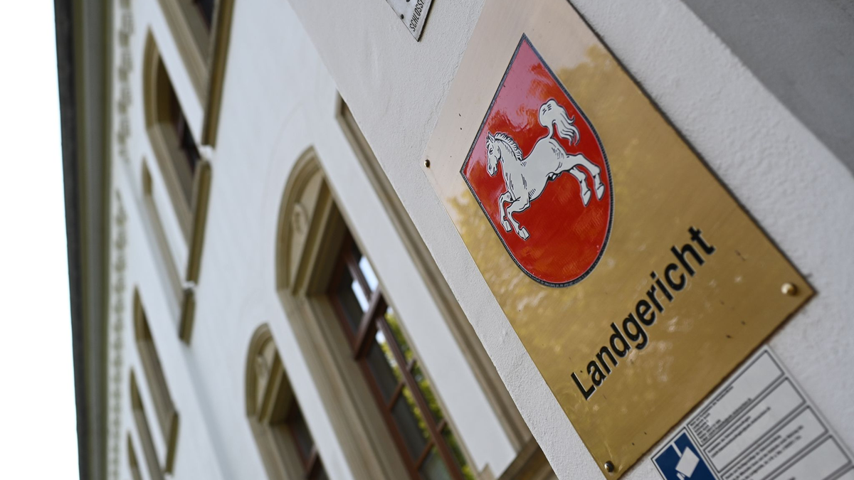 Ein Schild mit dem niedersächsischen Landeswappen am Eingang zum Landgericht Aurich. Dort wurde ein Prozess wegen Drogenhandels verhandelt. - Foto: Lars Penning/dpa