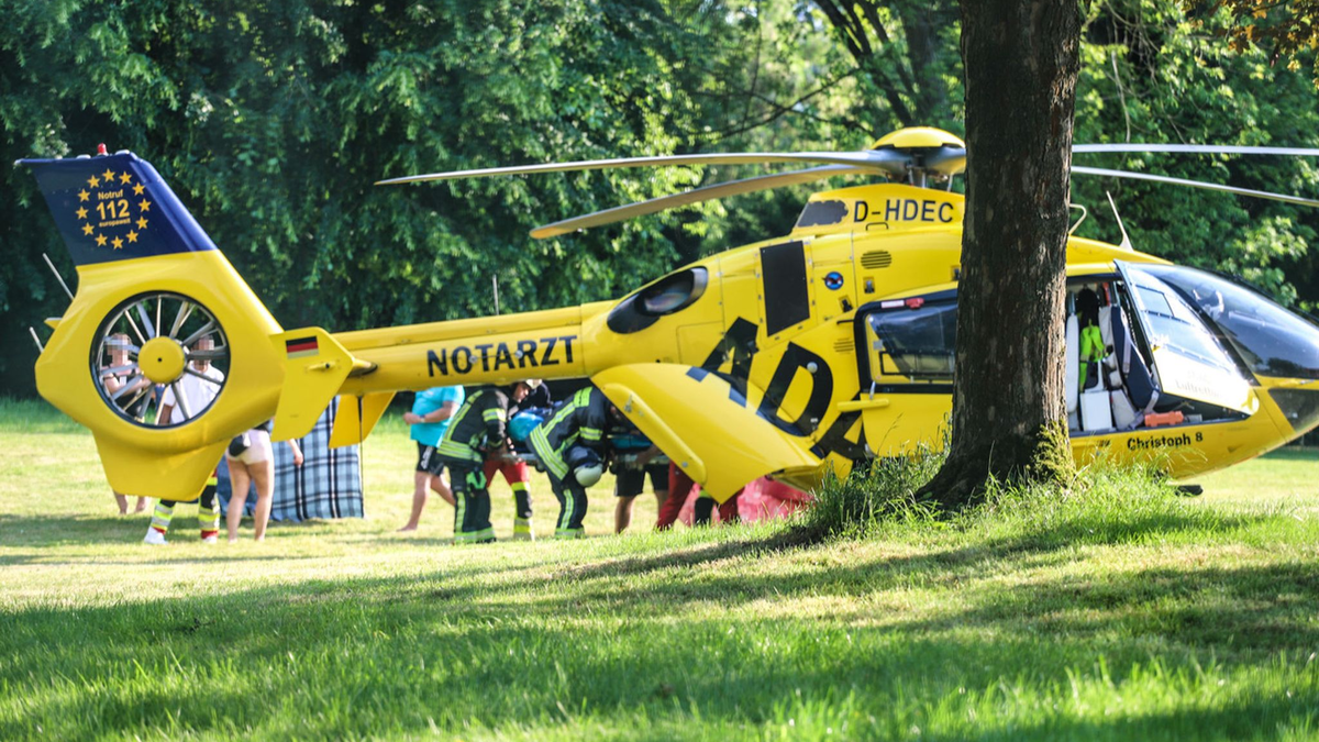 Ein Rettungshubschrauber im Naturbad am See im Einsatz, wo sich ein Kind beim Spielen schwer verletzt hat. - Foto: Alex Talash/dpa