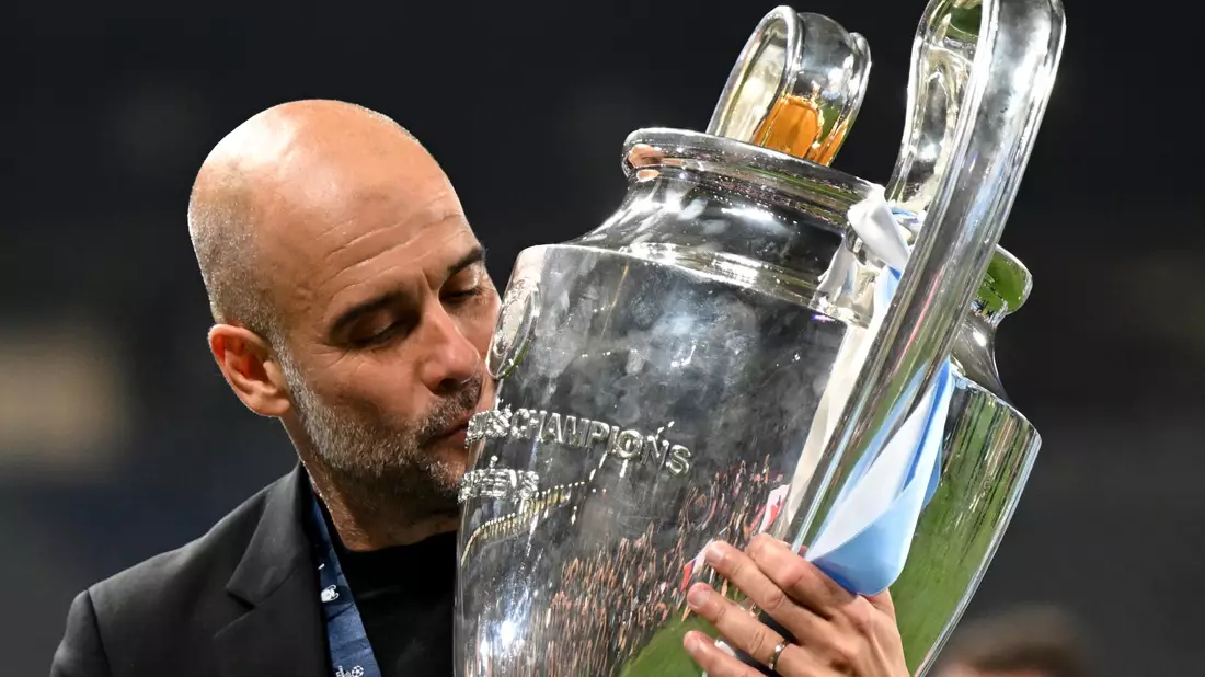 Manchesters Trainer Pep Guardiola küsst die Trophäe. - Bild: Robert Michael/dpa