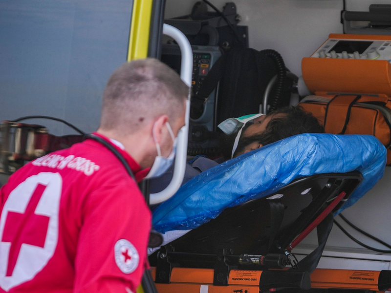 Das griechische Rote Kreuz in Kalamata hilft einem Überlebenden nach dem Bootsunglück. - Foto: Thanassis Stavrakis/AP/dpa