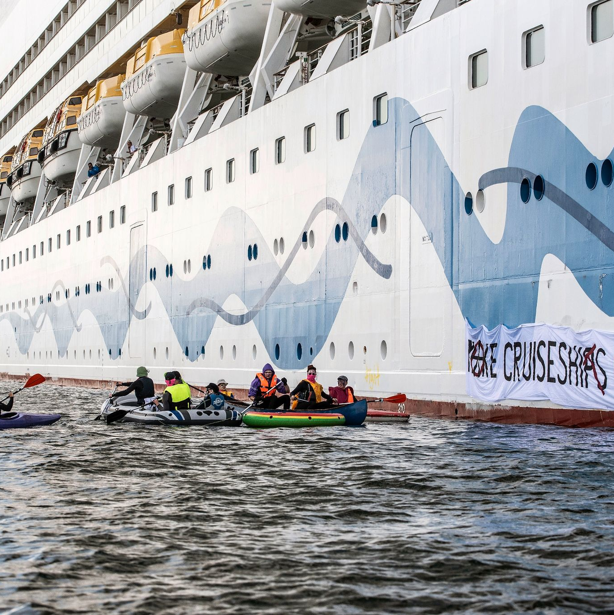 Klimaaktivisten versuchen, das Kreuzfahrtschiff «Aida Diva» am Auslaufen zu hindern. - Foto: Frank Hormann/dpa