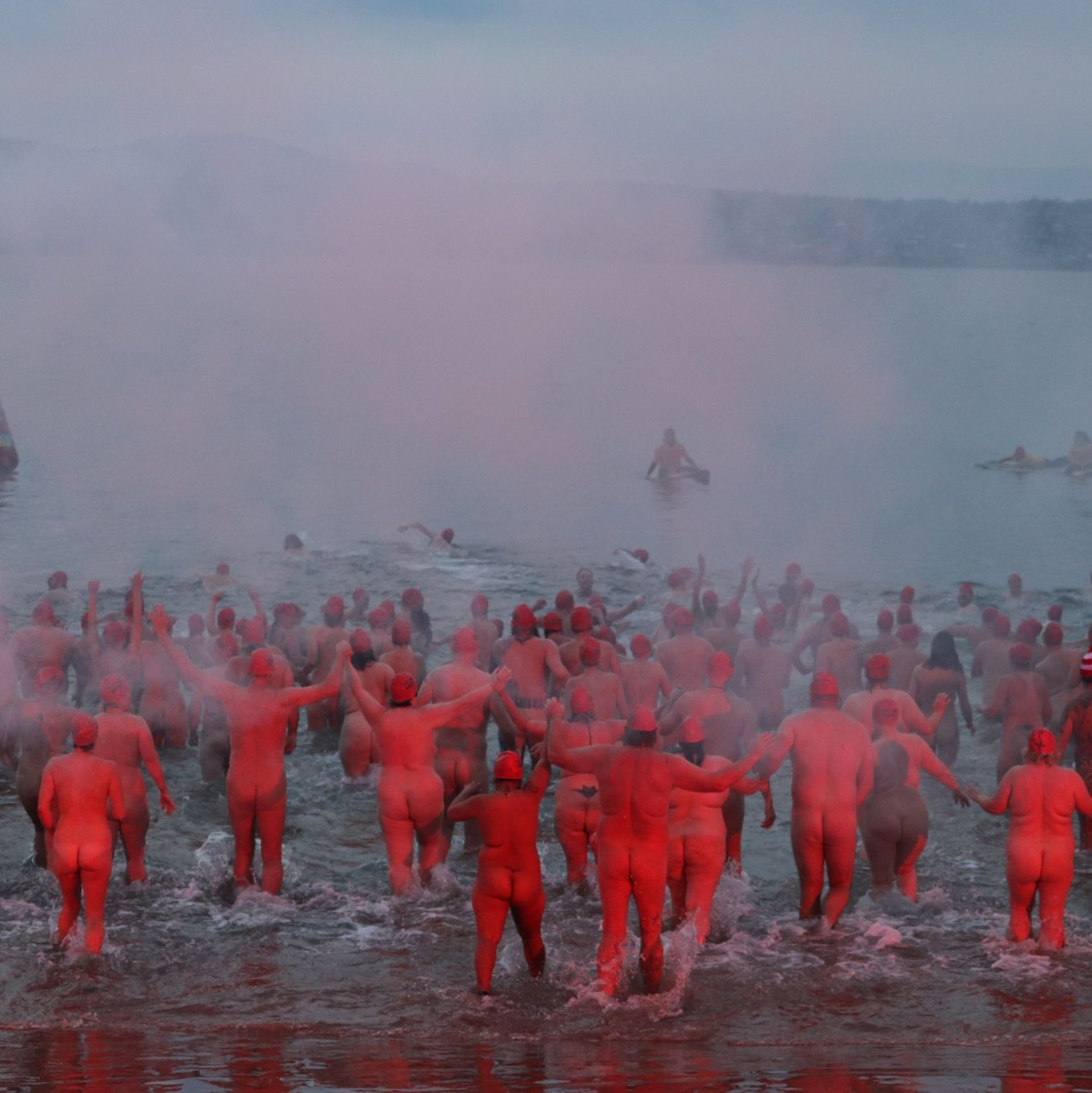 Menschen nehmen am jährlichen Nacktschwimmen zur Wintersonnenwende im tasmanischen Hobart teil. - Foto: Ethan James/AAP/dpa