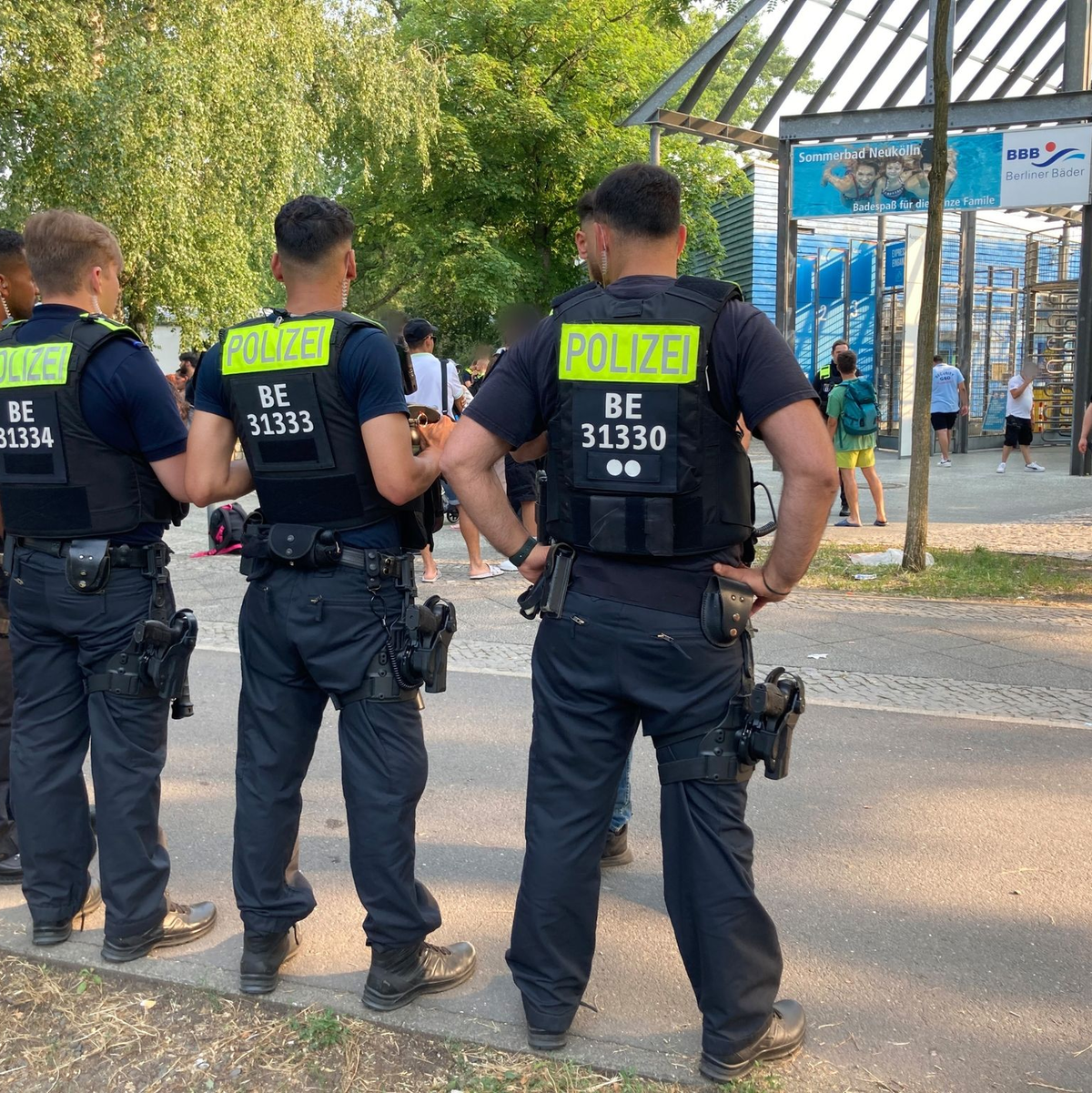 Polizisten stehen vor dem Eingang des Sommerbads in Neukölln. - Foto: Carioline Bock/dpa