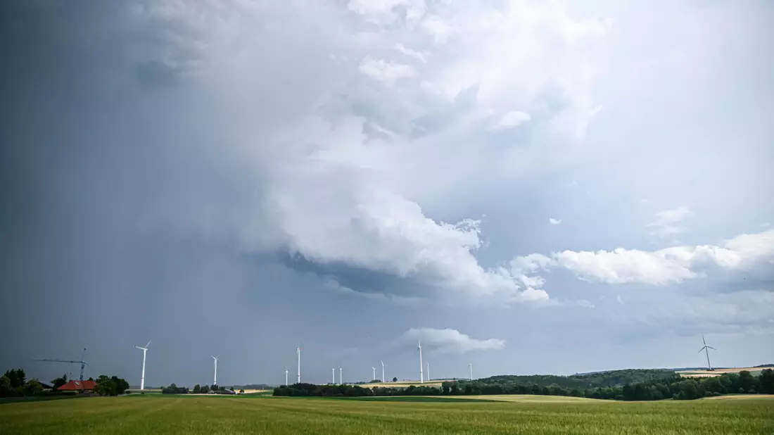 Eine Regenfront mit dunklen Wolken hinter einem Gerstenfeld. (Symbolbild) - Bild: Marius Bulling/dpa