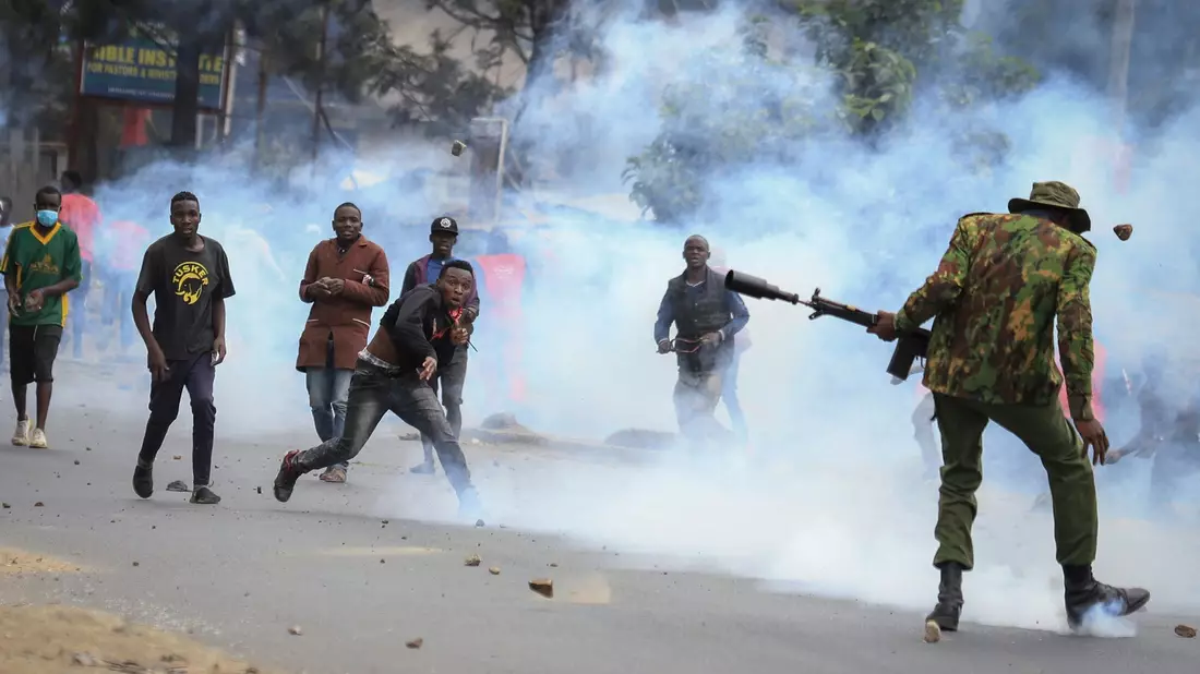 Zusammenstoß im Mathare-Viertel in Nairobi: Steine werfende Demonstranten und Polizisten, die Tränengas abfeuern. - Bild: AP/dpa
