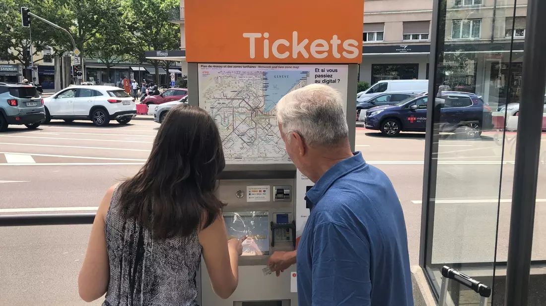 Zwei Leute versuchen, an einem Ticket-Automaten in Genf Fahrkarten zu erwerben. - Bild: Christiane Oelrich/dpa
