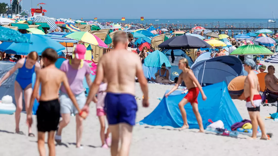 Urlauber am Ostseestrand in Grömitz: Nicht jeder kann es sich leisten, in den Ferien wegzufahren. - Bild: Markus Scholz/dpa