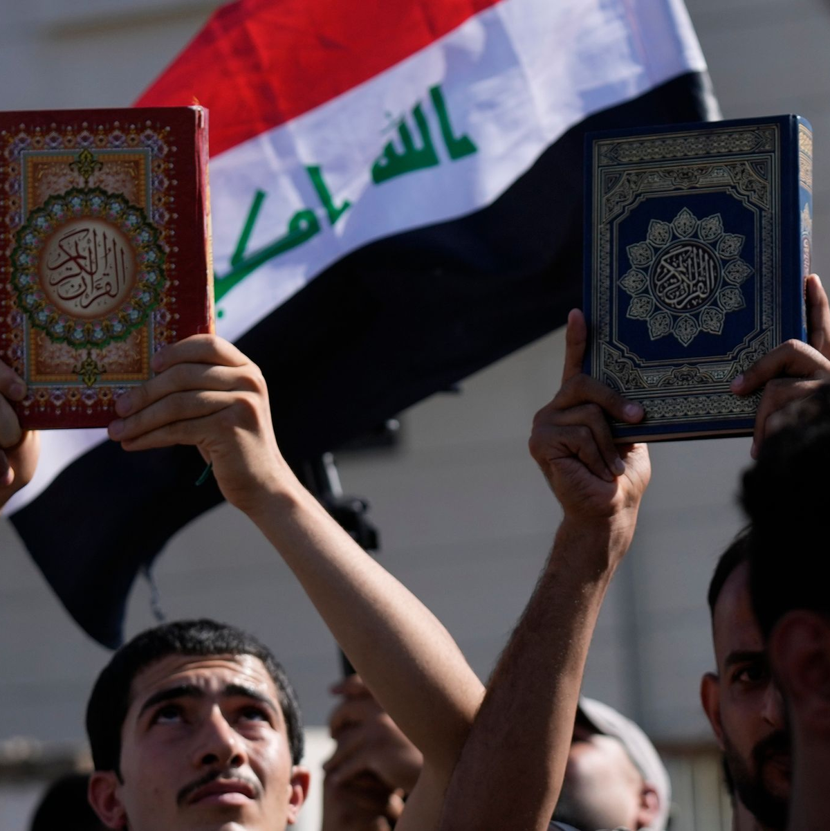Anhänger des schiitischen Geistlichen Muqtada al-Sadr halten den Koran, das heilige Buch der Muslime, während einer Demonstration vor der schwedischen Botschaft hoch. - Foto: Hadi Mizban/AP