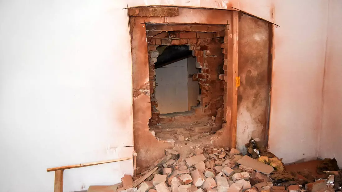 Durch ein großes Loch in der Wand gelangten Einbrecher in eine Wohnung in Bremerhaven. - Bild: Polizei Bremerhaven/dpa
