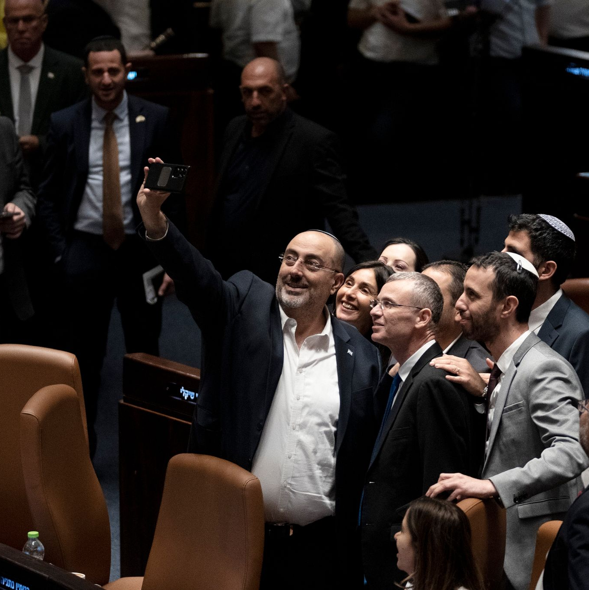 Abgeordnete machen in der Knesset ein Selfie mit Justizminister Jariv Levin (vorn M), nachdem das Parlament mit der Regierungsmehrheit ein Kernelement der Justizreform verabschiedet hat. - Foto: Maya Alleruzzo/AP/dpa
