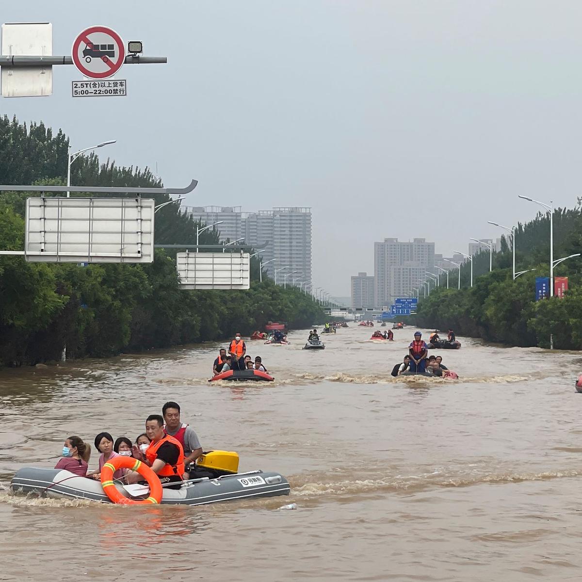 Mit Schlauchbooten werden Zivilisten südlich von Peking evakuiert. - Foto: Andy Wong/AP/dpa