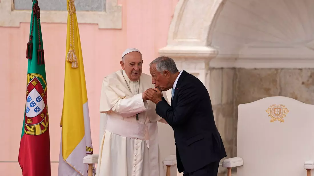 Bei der Willkommenszeremonie küsst der portugiesische Präsident Marcelo Rebelo de Sousa die Hand von Papst Franziskus. - Bild: Armando Franca/AP/dpa