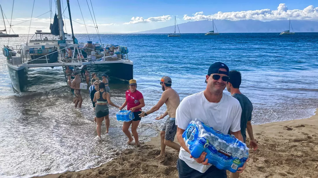 Freiwillige aus Maalaea Bay auf Maui entladen Spenden von einem Boot. - Bild: Rick Bowmer/AP/dpa