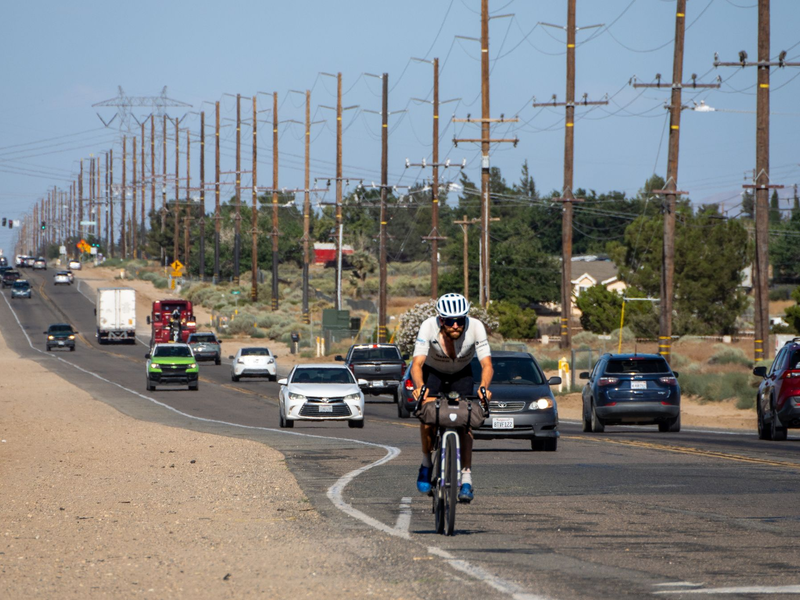 Der deutsche Athlet Jonas Deichmann fährt mit seinem Fahrrad eine Straße in den USA entlang. - Foto: Markus Weinberg/Jonas Deichmann/dpa