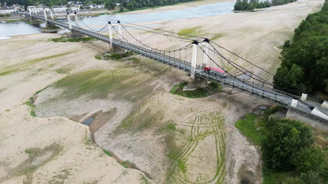 Dieses Luftbild zeigt eine Brücke über das ausgetrocknete Flussbett der Loire in Westfrankreich. - Bild: Damien Meyer/AFP/dpa