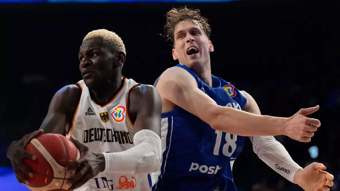 Isaac Bonga (l) sichert den Basketball gegen den Finnen Mikael Jantunen. - Bild: Hiro Komae/AP