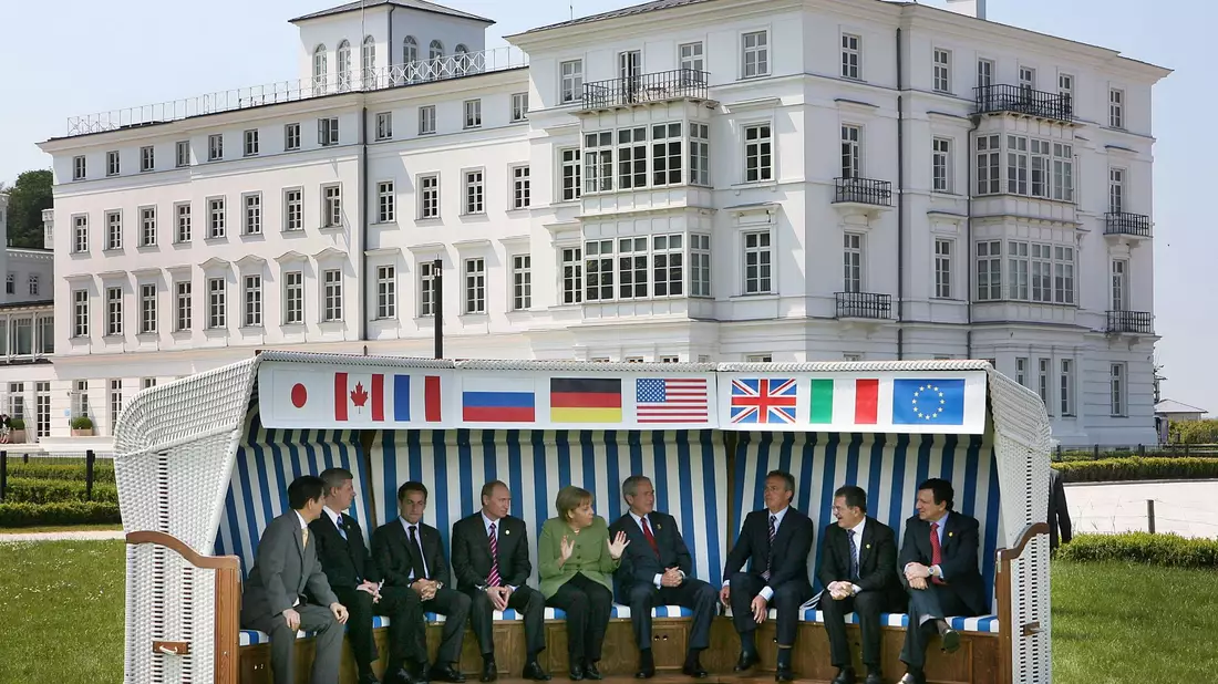 Angela Merkel sitzt zusammen mit anderen Regierungschefs in einem XXL-Strandkorb beim G8-Gipfel in Heiligendamm im Jahr 2007. - Bild: picture alliance / dpa