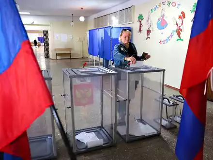 Eine Frau gibt in einem Wahllokal in Donezk ihre Stimme ab. - Foto: AP/dpa