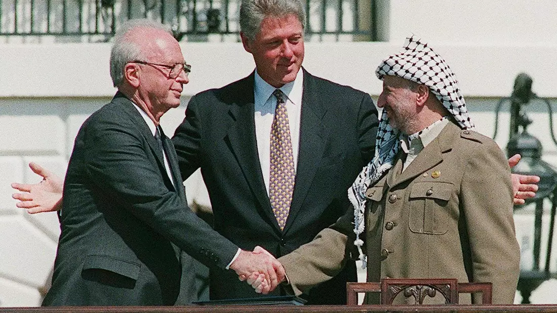Ein Handschlag, der die Hoffnungen auf einen Frieden zwischen Israel und den Palästinensern symbolisiert: Der damalige Ministerpräsident von Israel, Izchak Rabin (l), und Jassir Arafat (r), damaliger Vorsitzender der Palästinensischen Befreiungsorganisation PLO, geben sich im Beisein von Ex-US-Präsident Bill Clinton die Hand. - Bild: Avi Ohayon/Israeli Government Pr/EPA/dpa