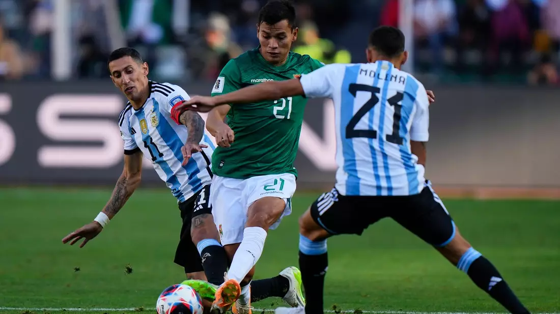 Boliviens Hector Cuellar in Aktion gegen die Argentinier Angel Di Maria (l) und Nahuel Molina (21). - Bild: Juan Karita/AP