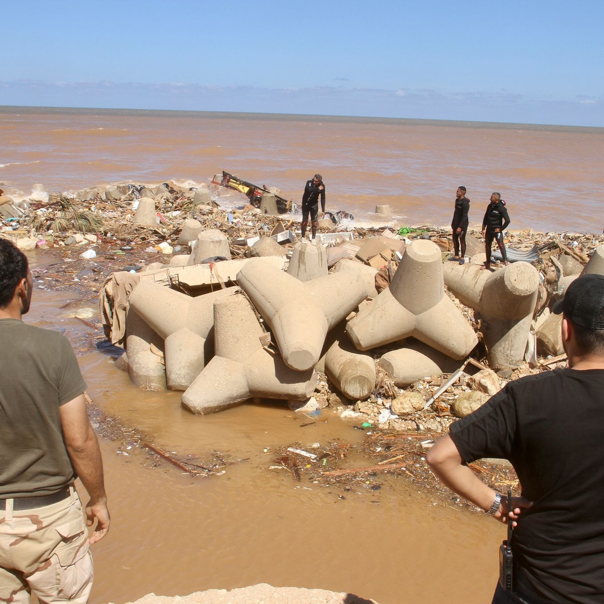 Ein Mann mit Krücken versucht, über Trümmer zu steigen. - Foto: Yousef Murad/AP/dpa