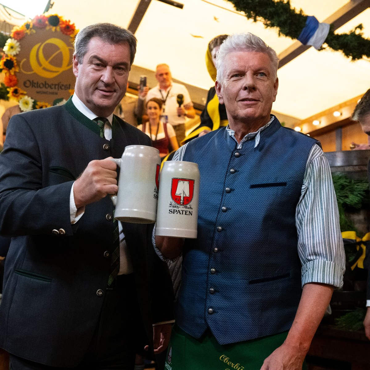 Markus Söder (l, CSU), Ministerpräsident von Bayern und Dieter Reiter (SPD), Oberbürgermeister von München, prosten sich nach dem traditionellen Fassanstich zu. - Foto: Sven Hoppe/dpa