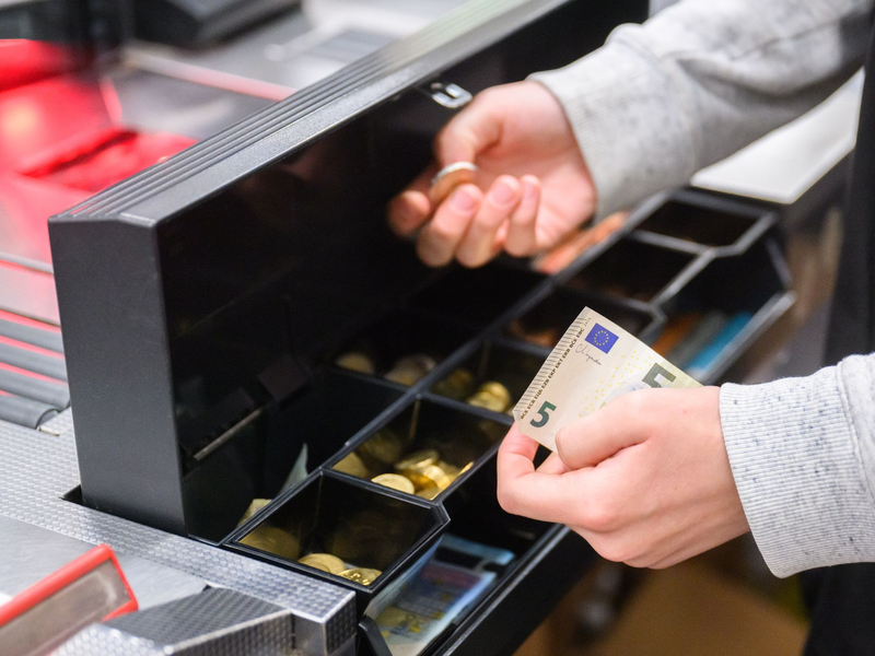 Eine Kassiererin gibt einer Kundin Wechselgeld an der Kasse eines Supermarktes. Die Inflation ist auf dem Rückzug. (Symbolbild) - Foto: Julian Stratenschulte/dpa