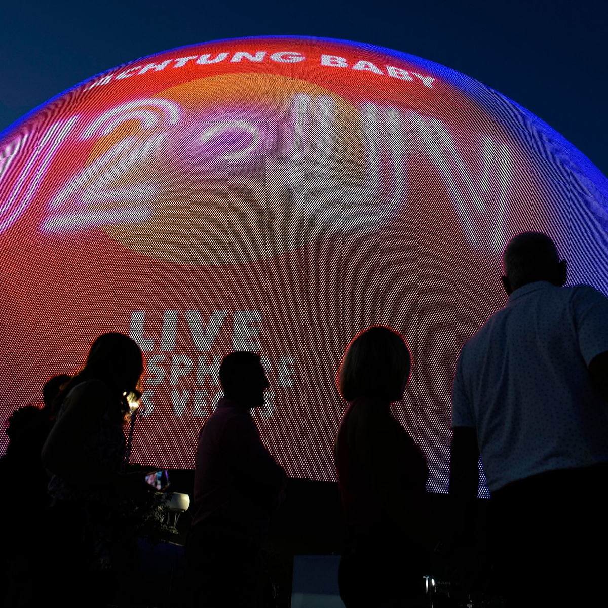 Menschen kommen zur Eröffnungsnacht der neuen, kugelförmige Eventhalle in Las Vegas. U2 wird bis Dezember an 25 Abenden dort auftreten. - Foto: John Locher/AP/dpa