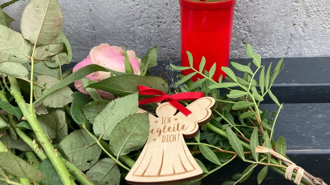 Blumen, Kerzen und ein Engel für eine  14-Jährige aus Nordhessen, die tot in einem Waldstück gefunden wurde. - Bild: Nicole Schippers/dpa
