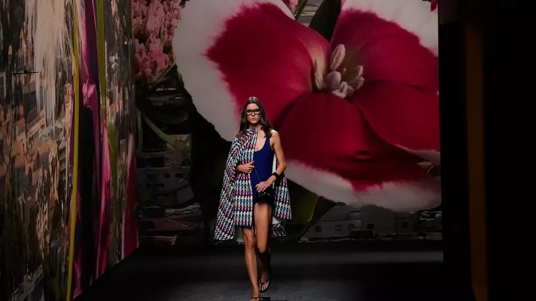 Ein Model trägt eine Kreation von Chanel - im Hintergrund: eine riesige Fototapete. - Bild: Christophe Ena/AP/dpa