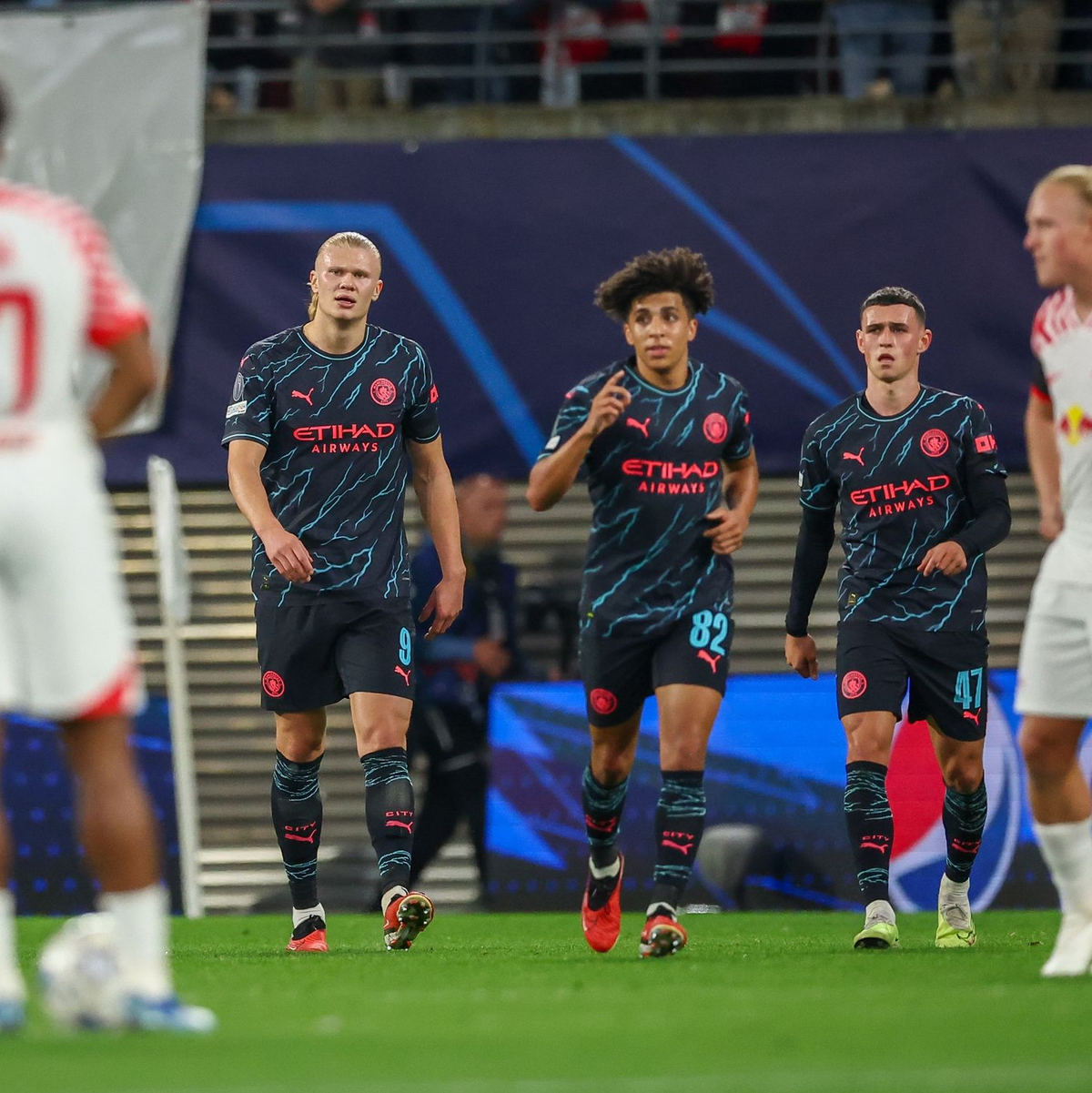Erling Haaland (l-r) und Rico Lewis feiern Phil Foden für dessen Führungstor. - Foto: Jan Woitas/dpa