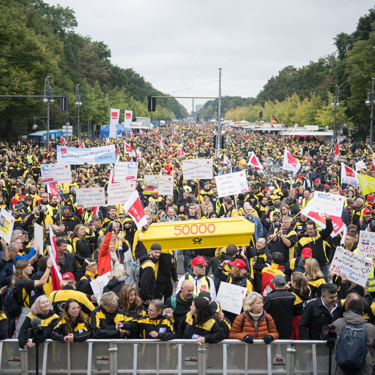 Postmitarbeiter stehen während einer Verdi-Großkundgebung zur Novelle des Postgesetzes auf der Straße des 17. Juni. - Foto: Sebastian Christoph Gollnow/dpa