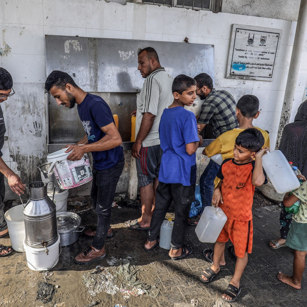 Palästinenser füllen an einem UN-Zentrum im Gazastreifen Flaschen mit Trinkwasser aus einem Wasserhahn. - Foto: Abed Rahim Khatib/dpa
