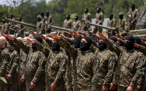 Pro-iranische Hisbollah-Kämpfer legen während einer inszenierten Militärübung in einem Lager im südlibanesischen Dorf Aramta einen Eid ab. - Foto: Marwan Naamani/dpa