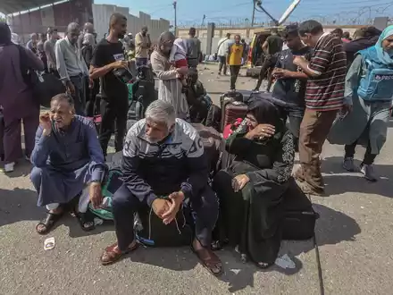 Palästinenser, einige mit ausländischen Pässen, warten am Grenzübergang Rafah auf Hilfe und eine mögliche Einreise nach Ägypten. - Foto: Mohammed Talatene/dpa
