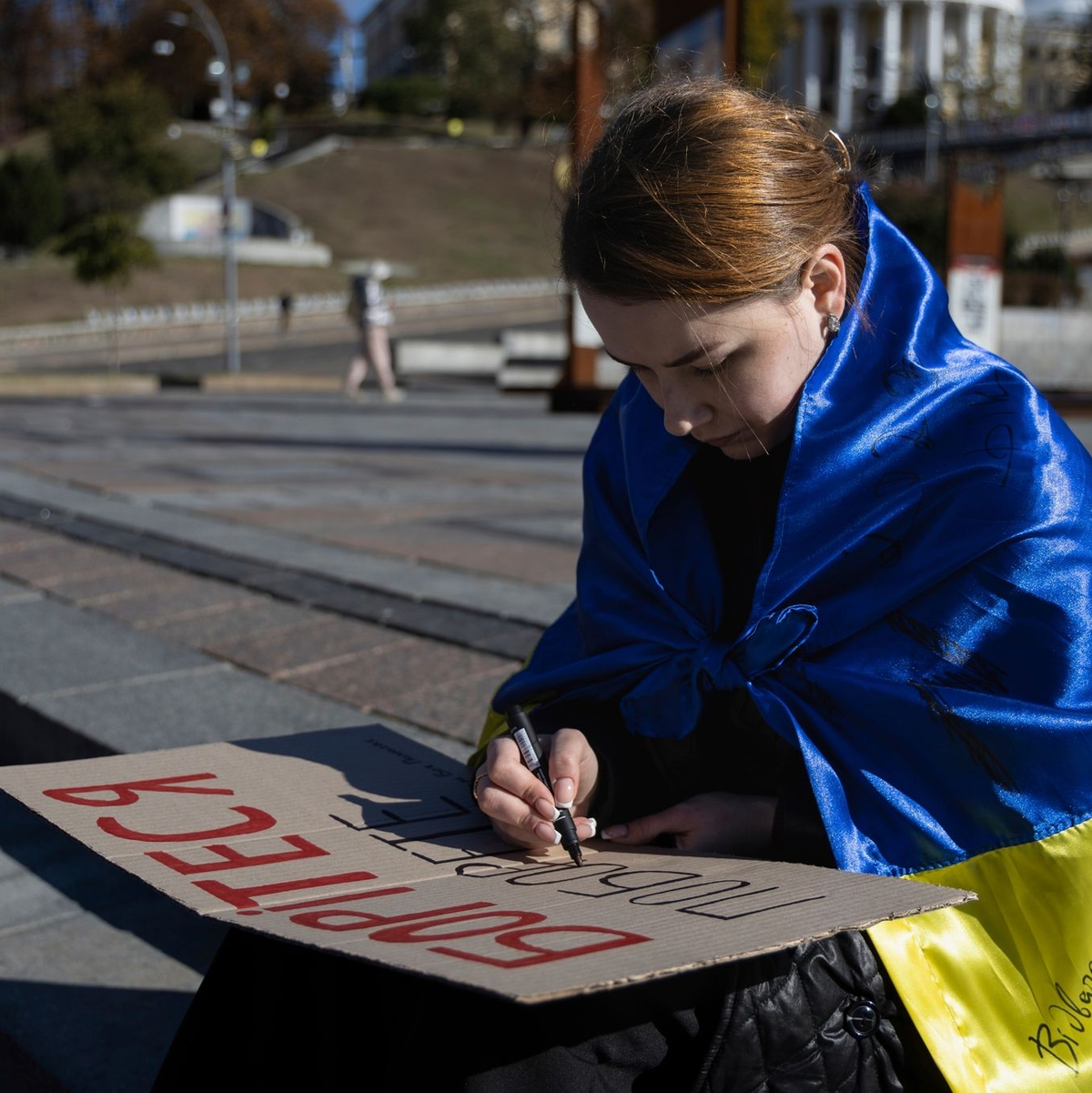 Eine Studentin in Kiew schreibt die ersten Worte des ukrainischen Gedichts «Kämpfe weiter - du wirst siegen» von Taras Schewtschenko auf ein Plakat. - Foto: Alex Babenko/AP/dpa