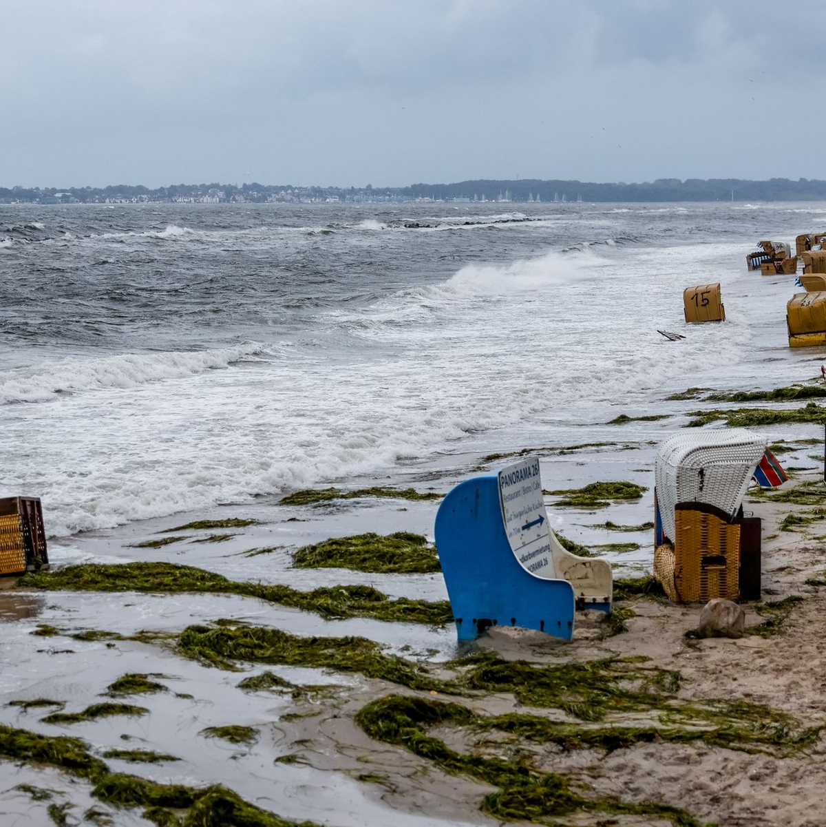 Einsatzkräfte der Feuerwehr sichern in  in Kiel-Schiksee Strandkörbe vor den Flutwellen der Ostsee. - Foto: Axel Heimken/dpa