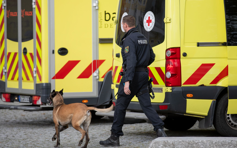 Ein Polizist läuft nach einer eingegangen Drohung mit einem Hund vor einer Grund- und Oberschule im ostsächsischen Pulsnitz: Ähnliche Einsätze gibt es heute in Thüringen und Baden-Württemberg. - Foto: Rocci Klein