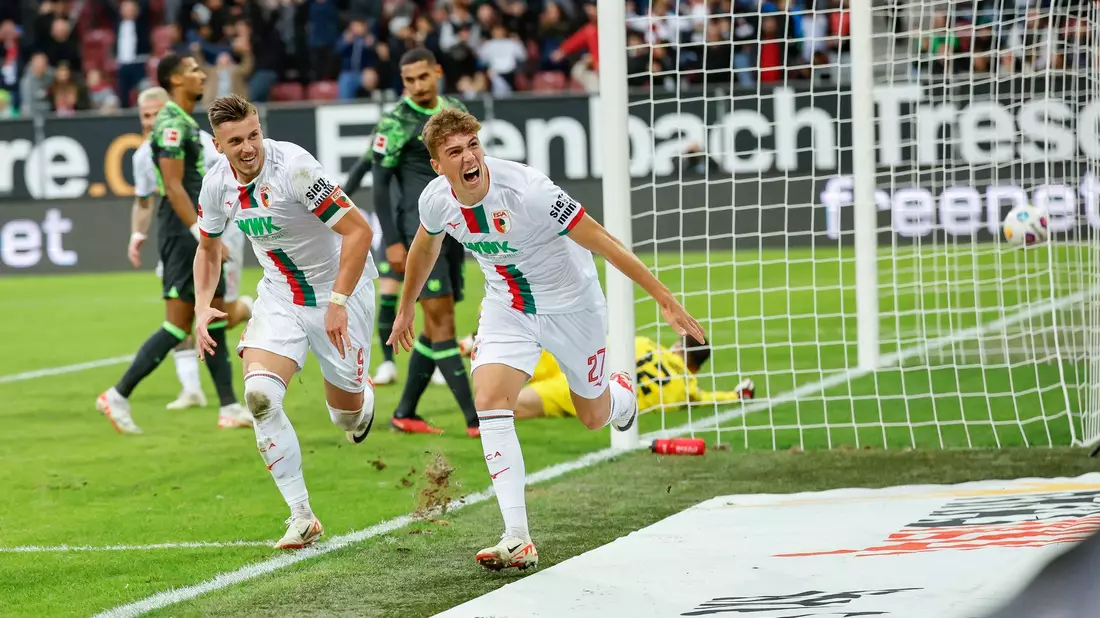 Arne Engels (r) schoss Augsburg zum Sieg gegen Wolfsburg. - Bild: Daniel Löb/dpa