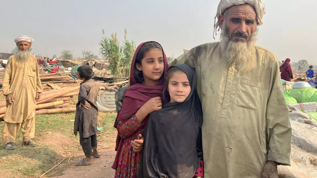 Ein afghanischer Vater und seine Töchter stehen zwischen den Überresten eines Flüchtlingslagers am Stadtrand von Islamabad, das von Bulldozern abgerissen wurde. - Bild: Nabila Lalee/dpa