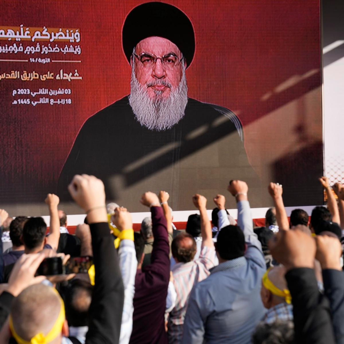 Anhänger der vom Iran unterstützten Hisbollah erheben in Beirut ihre Fäuste und jubeln, als Hisbollah-Führer Hassan Nasrallah während einer Kundgebung zum Gedenken an in den vergangenen Wochen getötete Hisbollah-Kämpfer über eine Videoverbindung erscheint. - Foto: Hussein Malla/AP