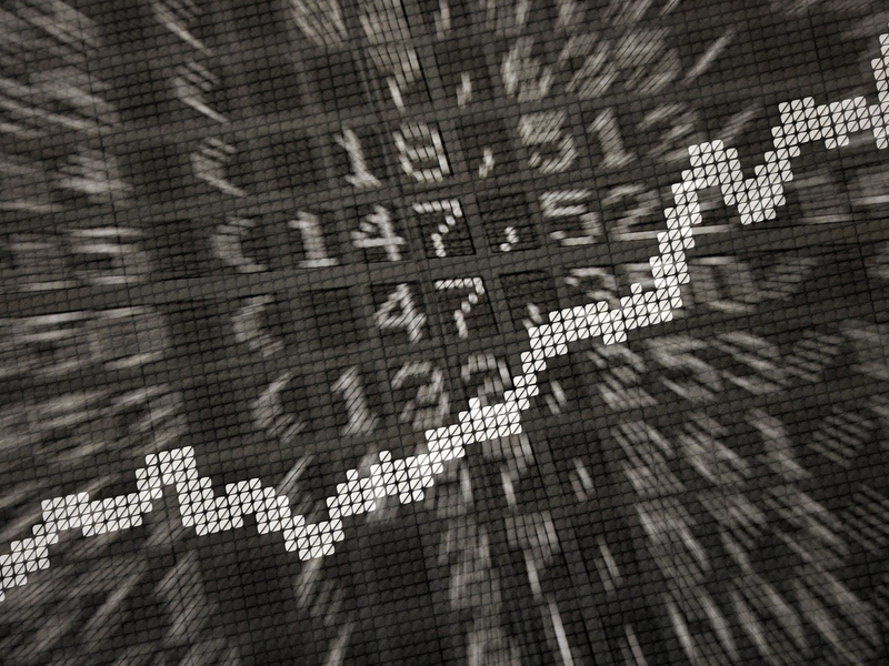 Die große Anzeige in der Börse zeigt die Dax-Kurve und verschiedene Börsenkurse: ETFs werden börsentäglich gehandelt. - Foto: Daniel Reinhardt/dpa