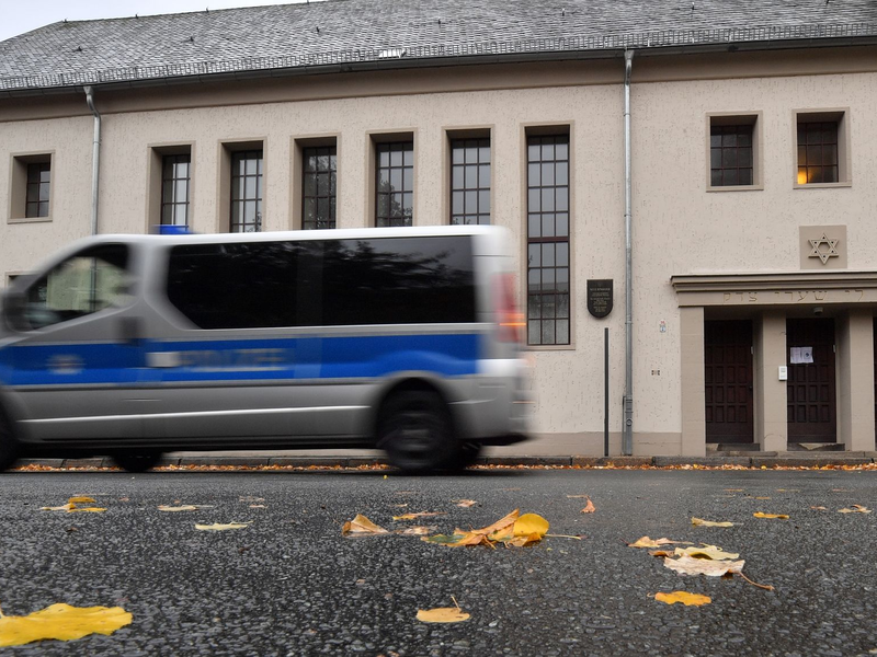 Ein Polizeifahrzeug fährt vor der Neuen Synagoge in Erfurt entlang. - Foto: Martin Schutt/dpa-Zentralbild/dpa