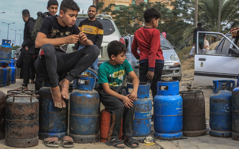 Palästinensische Kinder in Chan Junis stehen Schlange, um Flüssiggasflaschen aufzufüllen. - Foto: Mohammed Talatene/dpa